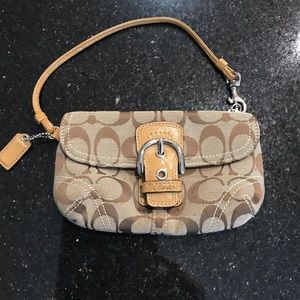 A Coach signature wristlet